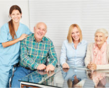 elderly family and caregiver smiling