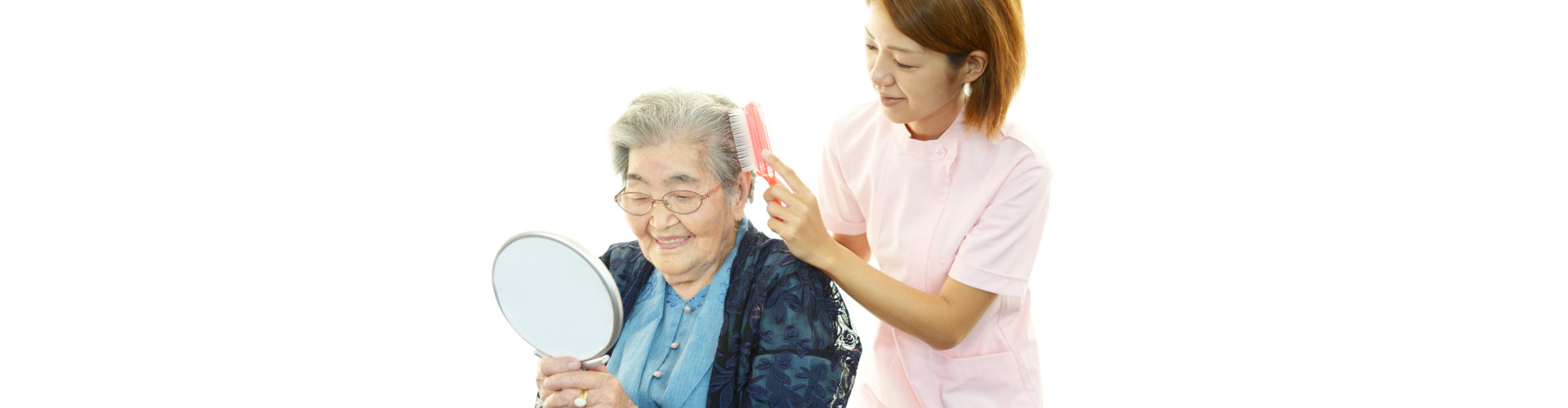 caregiver combing hair of an elderly woman